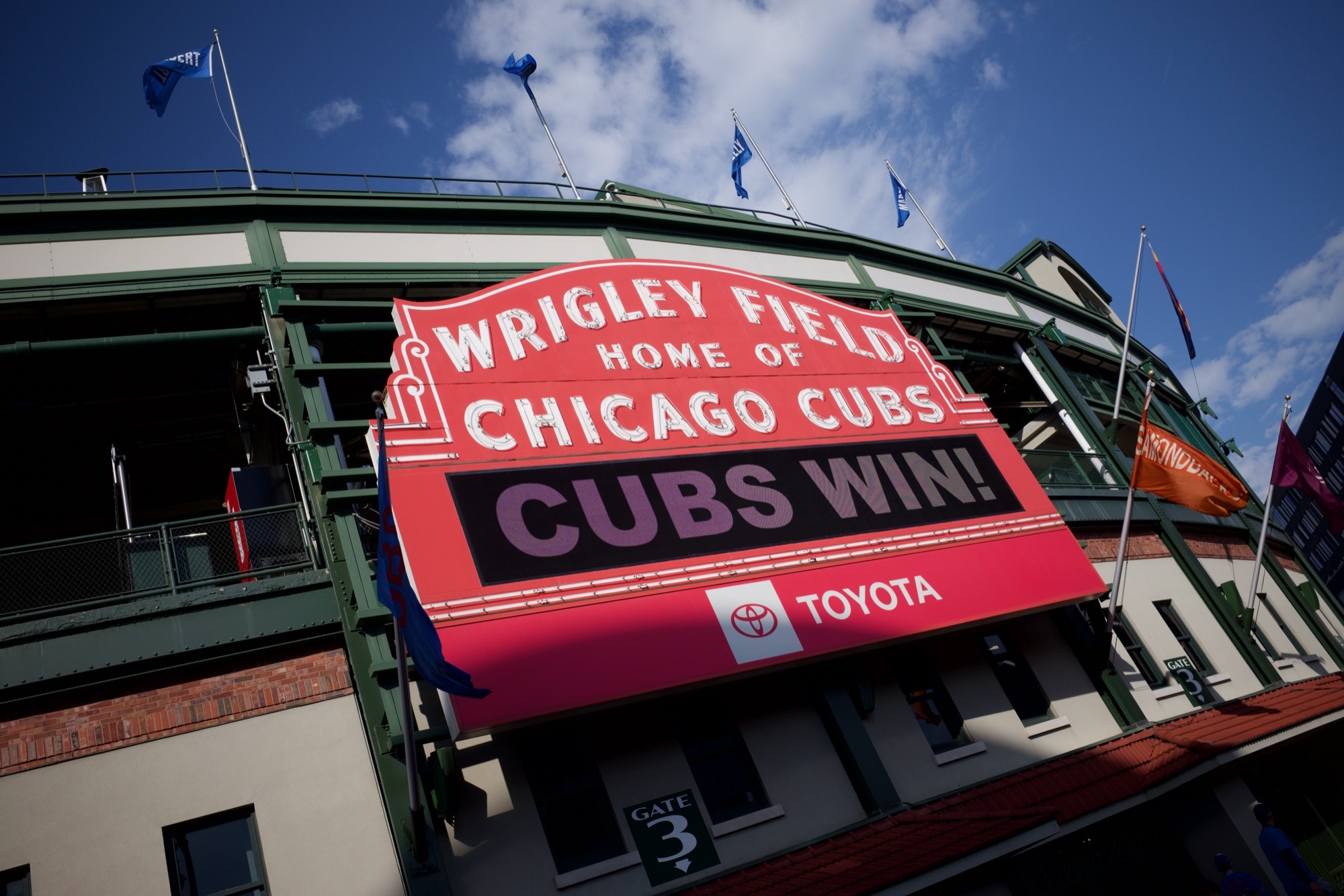 The legendary Wrigley Field neon sign announcing that the Cubs won the game.