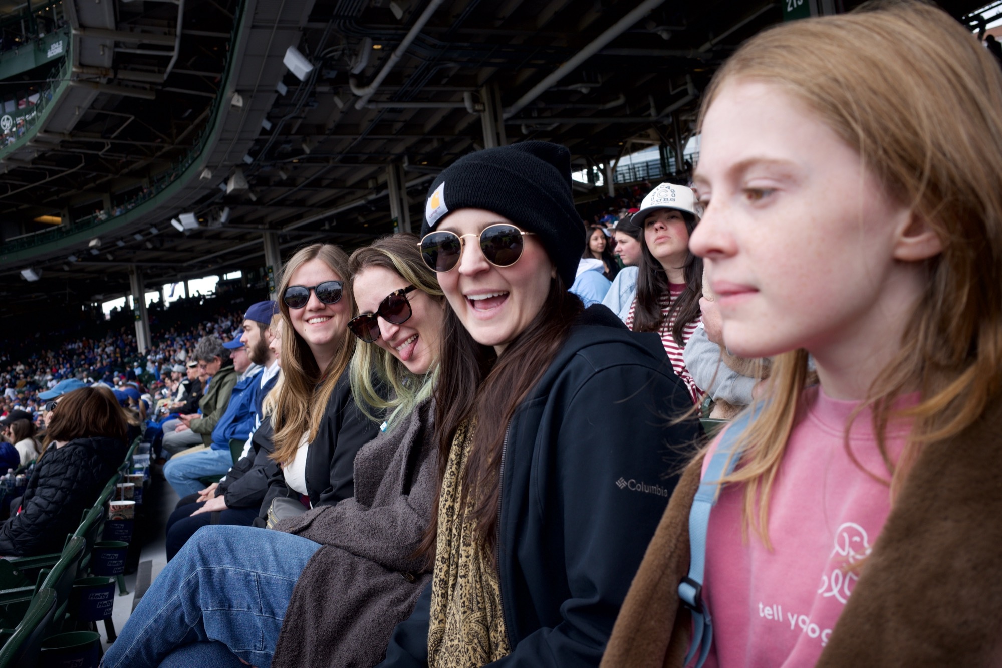 Olivia, Molly, Brittany, and Betty posing for the camera from their seats in the field.