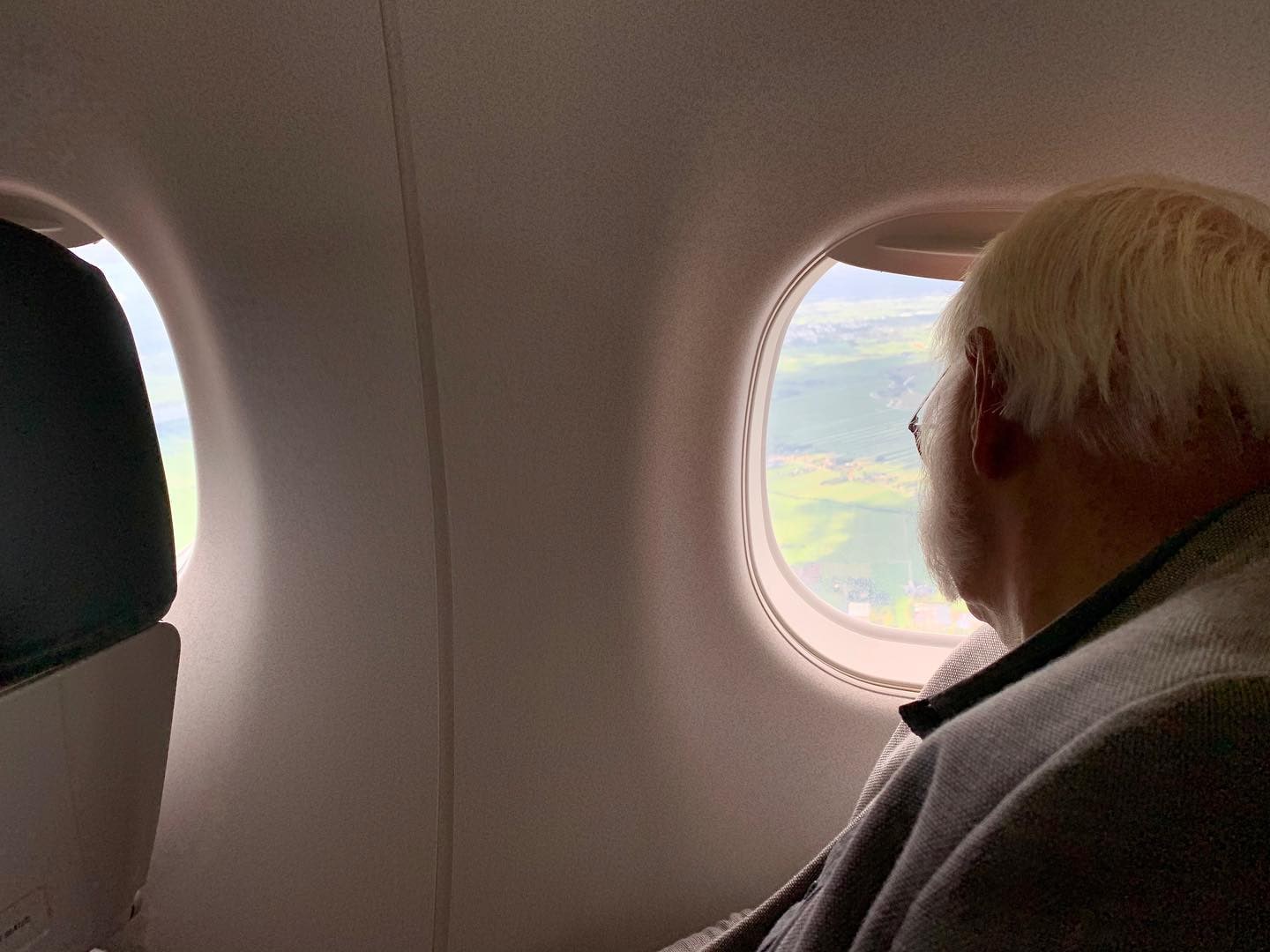 The man from Rotterdam sitting at the window seat in my row of the plane with a view of the Netherland countryside below.