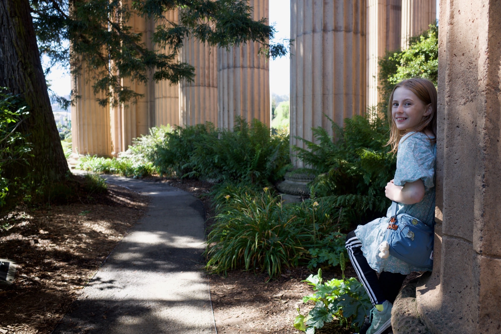 Betty leaning against a Romanesque column at the Palace of Fine Arts
